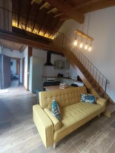 a living room with a couch and a staircase at MIRADOR DEL HITO I y MIRADOR DEL HITO II in Espinosa de Bricia