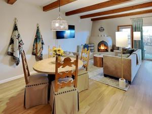 a living room with a table and a fireplace at Casa Cielo in Santa Fe
