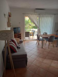 a living room with a couch and a table at Apartmani Antonio Basina in Vrbanj