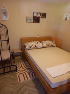 a bedroom with a bed with a ladder in it at Apartmani Antonio Basina in Vrbanj