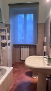 a bathroom with a tub and a sink and a window at Casa Rasiglia 2 House Smart in Casenove +14 photos