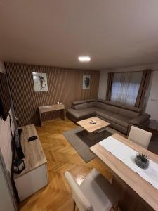 a living room with a couch and a table at Apartment Elize in Zagreb