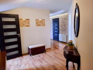 a hallway with a room with a door and a stool at Apartament Kleopatra in Limanowa +15 photos