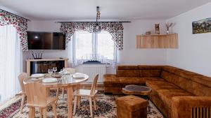 a living room with a couch and a table at Apartament Białka J6 in Białka Tatrzańska