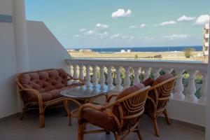 a balcony with two chairs and a table on a balcony at 36 Southwalk in Quseir