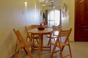 a dining room with a wooden table and chairs at 36 Southwalk in Quseir