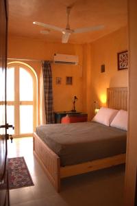 a bedroom with a large bed and a window at 36 Southwalk in Quseir