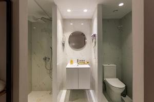 a bathroom with a toilet and a sink and a shower at Aether Athens Urban Hotel in Athens +77 photos