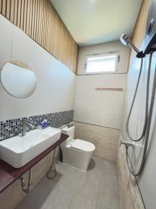 a bathroom with a sink and a toilet at Baan Lanta in Ko Po