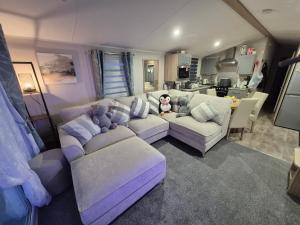a living room with a couch and a teddy bear at Cayton Bay Kestrel40 in Cayton