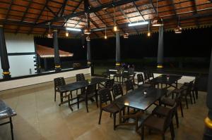 a group of tables and chairs in a restaurant at Aqua Terra Villas in Belūr