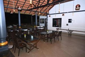 a dining room with tables and chairs in a building at Aqua Terra Villas in Belūr +54 photos