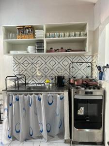a kitchen with a stove and a counter top at CASA MARAGOGI 3 Quartos in Maragogi