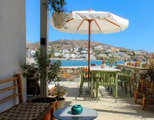 a patio with a table and an umbrella at Almyra in Finikas