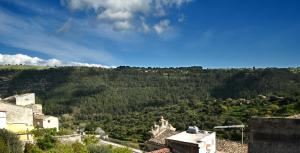 a view of a mountain with trees and buildings at Sud Casa Vacanze in Ragusa