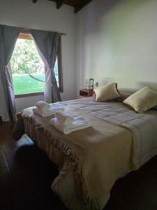 a bedroom with a large bed with towels on it at Pour Le Galerie in San Antonio de Areco +17 photos