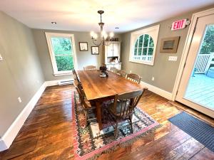 a dining room with a wooden table and chairs at Mill Pond Inn in Jefferson