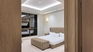 a bedroom with a bed and a window at O2P Al Salam in Medina