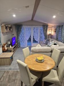 a living room with a table and a couch at Cayton Bay Kestrel40 in Cayton