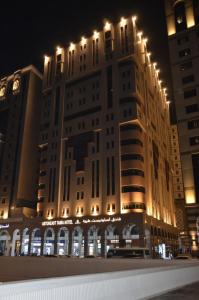 a large building with lights on top of it at ASTONEAST TAIBA Hotel in Medina