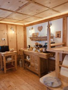 a large kitchen with wooden walls and wooden floors at B&B Luggla - sauna in camera in Predoi