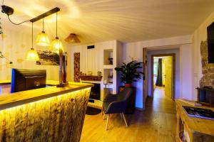 a living room with a bar and a dining room at B&B Luggla - sauna in camera in Predoi