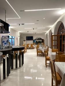 a dining room with tables and chairs in a restaurant at Hotel Bar-Restorant Fresku in Fushë-Arrëz