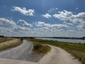a dirt road next to a body of water at Q80 Appartement in Schermbeck