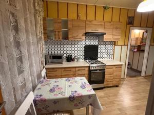 a kitchen with a table and a table and a table and a table at Pod Dębem in Białowieża +9 photos