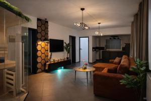 a living room with a couch and a fire place at Wellnesshaus - Whirlpool - Sauna - Relax in Herten