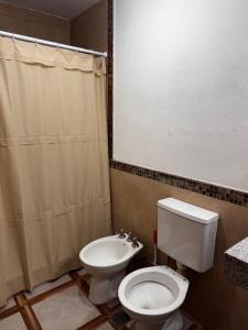 a bathroom with a toilet and a sink at Casa Bati in El Mollar +16 photos