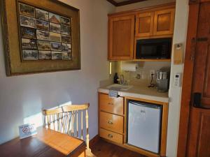 a small kitchen with a table and a microwave at Oak Hill Inn in Julian +16 photos