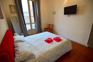 a bedroom with a bed with two red roses on it at Cà dla Madamina in Turin