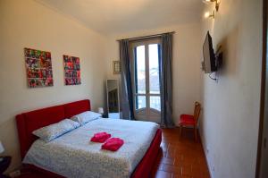 a bedroom with a bed with red towels on it at Cà dla Madamina in Turin