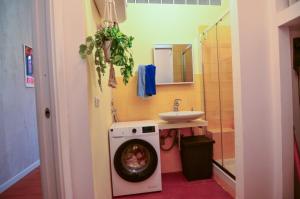 a bathroom with a washing machine next to a sink at Cà dla Madamina in Turin +21 photos