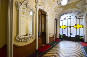an ornate hallway with a door and a window at Cà dla Madamina in Turin
