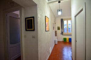 a hallway with white walls and a tile floor at Cà dla Madamina in Turin