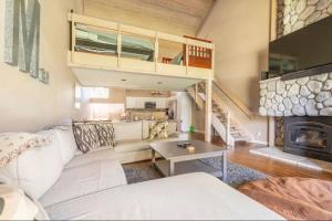a living room with a white couch and a fireplace at Snowcreek 569 in Mammoth Lakes