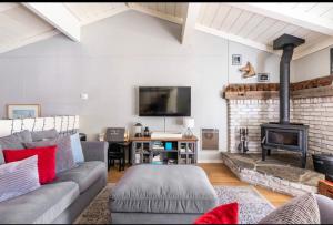 a living room with a couch and a fireplace at Villa De Los Pinos 15 in Mammoth Lakes