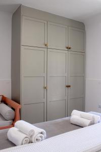 a bedroom with white cabinets and white towels at Almyra in Finikas