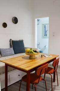 a dining room table with a bowl of fruit on it at Almyra in Finikas