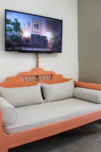 a couch with a television on a wall at Almyra in Finikas