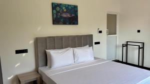 a bedroom with a bed with white pillows at EK Breeze Kalutara in Kalutara