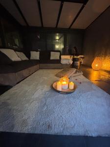 a room with a bed with two candles on it at L abricosy in Drancy +5 photos