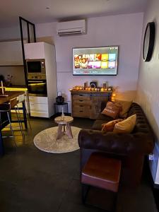 a living room with a couch and a kitchen at L abricosy in Drancy
