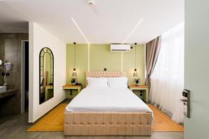 a bedroom with a large bed and a mirror at Aether Athens Urban Hotel in Athens