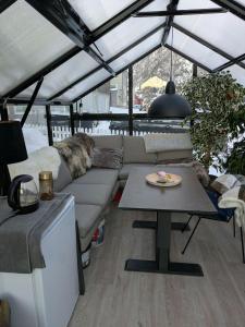 a living room with a couch and a table at E&E Apartment Junior in Svolvær