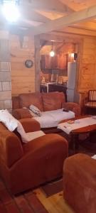 a living room with two couches and a kitchen at Vikendica strane in Mateševo