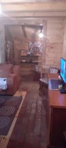 a living room with a couch and a desk with a computer at Vikendica strane in Mateševo