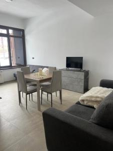 a living room with a table and chairs and a couch at Lemon Suite - Titty's Studio - Limone Piemonte in Limone Piemonte